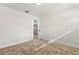 Empty bedroom featuring neutral carpet, white trim and an open door at 7320 Fieldcrest Ave, Winter Park, FL 32792