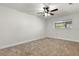 Empty bedroom with neutral carpet, a ceiling fan, and a window bringing in natural light at 7320 Fieldcrest Ave, Winter Park, FL 32792