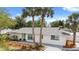 Charming single-story home with a beautifully landscaped front yard and an inviting teal-colored front door at 7320 Fieldcrest Ave, Winter Park, FL 32792