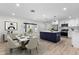 Kitchen and dining area with an island, stainless steel appliances, and modern decor at 7320 Fieldcrest Ave, Winter Park, FL 32792
