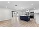 Kitchen and dining area with a center island, stainless steel appliances, and wood flooring at 7320 Fieldcrest Ave, Winter Park, FL 32792