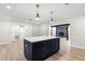 Kitchen island with pendant lights and view into the living spaces at 7320 Fieldcrest Ave, Winter Park, FL 32792