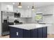 Kitchen featuring an island, stainless steel appliances, and marble subway tile backsplash at 7320 Fieldcrest Ave, Winter Park, FL 32792