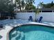 Backyard pool features privacy fence, ladder and lounge chairs for relaxing at 7320 Fieldcrest Ave, Winter Park, FL 32792