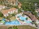 Aerial view of resort-style amenities, including a large pool, water slide, and well-maintained landscaping at 7666 Sir Kaufmann Ct, Kissimmee, FL 34747