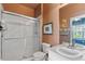 Bathroom featuring a glass enclosed shower, and double vanity at 7666 Sir Kaufmann Ct, Kissimmee, FL 34747