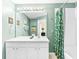 Bathroom featuring a tub-shower combo, a large mirror and a white vanity at 7666 Sir Kaufmann Ct, Kissimmee, FL 34747