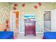 Bedroom featuring two twin beds, colorful wall decor and paint, with en-suite bathroom at 7666 Sir Kaufmann Ct, Kissimmee, FL 34747