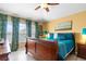 Serene bedroom featuring a king-sized bed, and two windows offering plenty of natural light at 7666 Sir Kaufmann Ct, Kissimmee, FL 34747