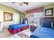 Comfortable bedroom with twin beds, neutral paint, and a window offering plenty of natural light at 7666 Sir Kaufmann Ct, Kissimmee, FL 34747