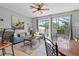 Comfortable living room with a sectional sofa, sliding door to the screened-in patio and pool at 7666 Sir Kaufmann Ct, Kissimmee, FL 34747