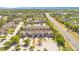 An aerial view showcases the townhome exteriors, landscaping, and street layout of the neighborhood at 10124 Shadow Leaf Ct, Orlando, FL 32825