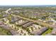 A high-angle aerial photograph features townhome exteriors and surrounding neighborhood streets and landscaping at 10124 Shadow Leaf Ct, Orlando, FL 32825