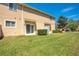 Backyard features a lawn and sliding glass door entry at 10124 Shadow Leaf Ct, Orlando, FL 32825