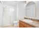 Bathroom features a wood vanity with sink and mirror plus a glass shower at 10124 Shadow Leaf Ct, Orlando, FL 32825