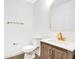 Stylish half bathroom with modern fixtures, wood vanity, and a golden framed mirror at 10124 Shadow Leaf Ct, Orlando, FL 32825