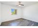 Bright bedroom features wood-look flooring, ceiling fan and a sunlit window at 10124 Shadow Leaf Ct, Orlando, FL 32825