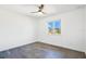 Minimalist bedroom with wood-look flooring, ceiling fan, and ample natural light at 10124 Shadow Leaf Ct, Orlando, FL 32825