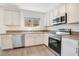 Well-lit kitchen with stainless steel appliances, stone backsplash, and updated cabinets at 10124 Shadow Leaf Ct, Orlando, FL 32825