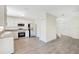 Spacious living room showcases wood-look floors and leads to the kitchen and front entryway at 10124 Shadow Leaf Ct, Orlando, FL 32825