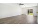 Bright, open living room with sliding glass doors and wood-look flooring at 10124 Shadow Leaf Ct, Orlando, FL 32825