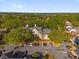 Aerial view showcasing an apartment building, adjacent parking, and a backdrop of lush greenery at 1013 S Hiawassee Rd # 3628, Orlando, FL 32835