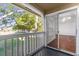 Balcony view of the lush landscaping and tree lined street with sliding glass door access at 1013 S Hiawassee Rd # 3628, Orlando, FL 32835