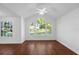 Bright bedroom with three large windows offering a scenic view and hardwood floor at 1013 S Hiawassee Rd # 3628, Orlando, FL 32835