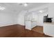 Well-lit living room and kitchen area with hardwood floors and bright white walls at 1013 S Hiawassee Rd # 3628, Orlando, FL 32835