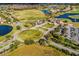Aerial view of the community with a beautiful golf course and surrounding waterways at 10255 Beechwood Ln, Orlando, FL 32832