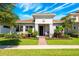 Charming single-story home with a well-manicured lawn, lush landscaping, and a classic tile roof at 10255 Beechwood Ln, Orlando, FL 32832