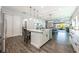 Bright kitchen featuring stainless steel appliances, a central island with pendant lighting, and wood-look tile flooring at 10255 Beechwood Ln, Orlando, FL 32832