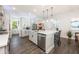 Bright kitchen featuring stainless steel appliances, a central island with pendant lighting, and wood-look tile flooring at 10255 Beechwood Ln, Orlando, FL 32832