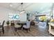 Open-concept living space with modern decor, a dining area, and a seamless transition to the outdoor patio at 10255 Beechwood Ln, Orlando, FL 32832