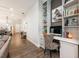 Versatile living space featuring a built-in desk, stylish decor, and wood-look tile flooring at 10255 Beechwood Ln, Orlando, FL 32832