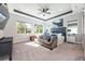 Spacious main bedroom with tray ceilings, three large windows, and comfortable seating area for relaxation at 10255 Beechwood Ln, Orlando, FL 32832