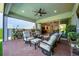 Relaxing covered patio with outdoor seating and scenic views of the lush green surroundings at 10255 Beechwood Ln, Orlando, FL 32832