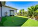 Lush backyard putting green featuring manicured landscaping, perfect for leisurely afternoons and golf practice at 10255 Beechwood Ln, Orlando, FL 32832