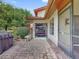 A view of a golf cart parked in a garage off a brick drive with tropical landscaping at 112 Coventry Ln, Haines City, FL 33844
