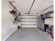 Spacious garage with ample storage solutions, including cabinets, a workbench, and wall-mounted bicycle racks at 112 Coventry Ln, Haines City, FL 33844
