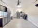 Functional garage with washer and dryer, extra refrigerator, ample cabinet storage and a workbench area at 112 Coventry Ln, Haines City, FL 33844