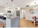 Bright kitchen boasts updated appliances, granite counters, light cabinets, and an island with bar seating at 112 Coventry Ln, Haines City, FL 33844