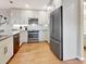 Contemporary kitchen with stainless steel appliances, light cabinets, subway tile backsplash, and wood-style flooring at 112 Coventry Ln, Haines City, FL 33844