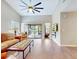 Spacious living room with vaulted ceilings, tile flooring, and a sliding glass door to the patio at 112 Coventry Ln, Haines City, FL 33844