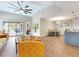 Open-concept living area featuring a large ceiling fan, hardwood floors, and access to a screened-in porch at 112 Coventry Ln, Haines City, FL 33844