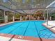 Outdoor pool is enclosed with pool depth markings, access ladders, and safety features at 112 Coventry Ln, Haines City, FL 33844