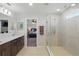 Modern bathroom featuring tile flooring, dual sinks, and a glass-enclosed shower, offering a spa-like experience at 1158 Oak Bluff Dr, Davenport, FL 33837