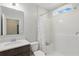 Well-lit bathroom featuring a shower over tub combination and a dark vanity with light countertop at 1158 Oak Bluff Dr, Davenport, FL 33837