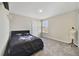 Carpeted bedroom with window, closet, and stylish decor at 1158 Oak Bluff Dr, Davenport, FL 33837