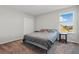 Comfortable bedroom with neutral tones and carpet flooring, featuring a double bed and natural light at 1158 Oak Bluff Dr, Davenport, FL 33837